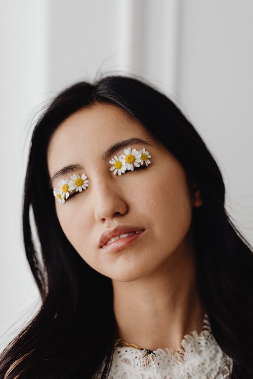 
A Woman with Chamomile Flowers on Her Eyelids