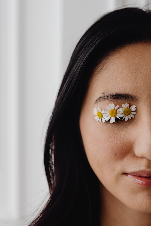 A Woman with Chamomile Flowers on Her Eye
