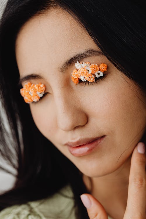 Woman with Orange and White Flowers on Eyes