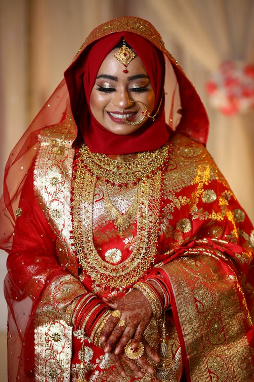 A Beautiful Woman in Red and Gold Sari