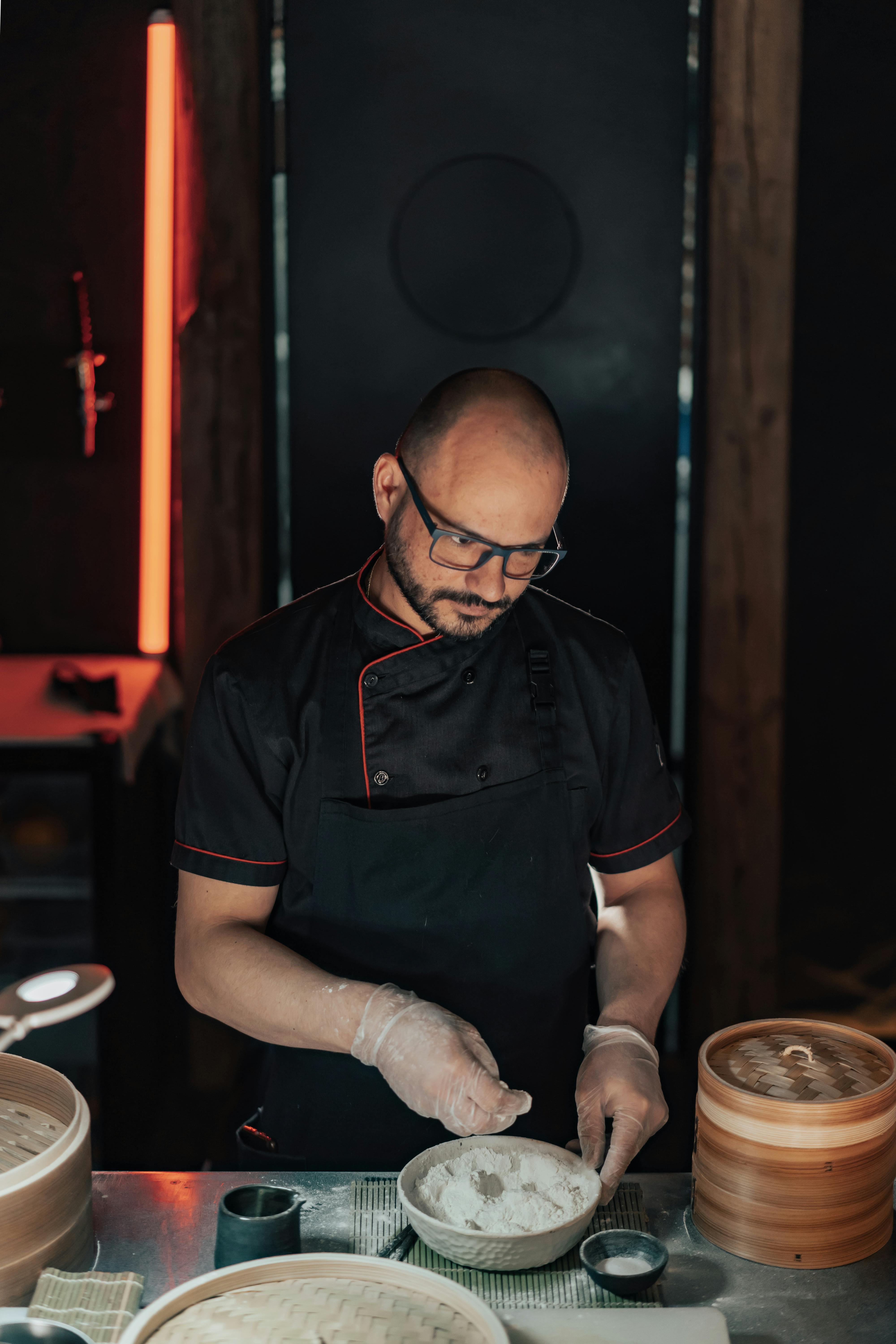 man in black chef shirt cooking