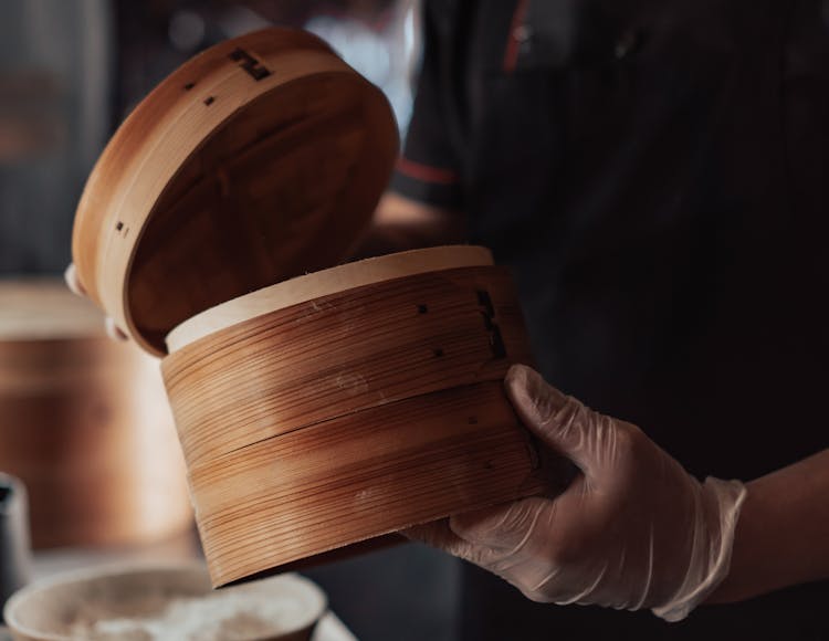 Person Holding Bamboo Round Steamer Basket