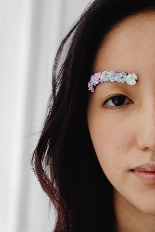 Woman with Purple and White Flowers on Eyebrow