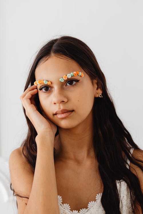 Woman in White Tank Top with Flowers on Eyebrows