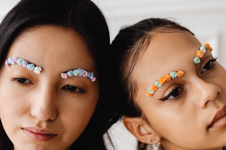 Close-Up Shot Of Two Girls With Flower Brows