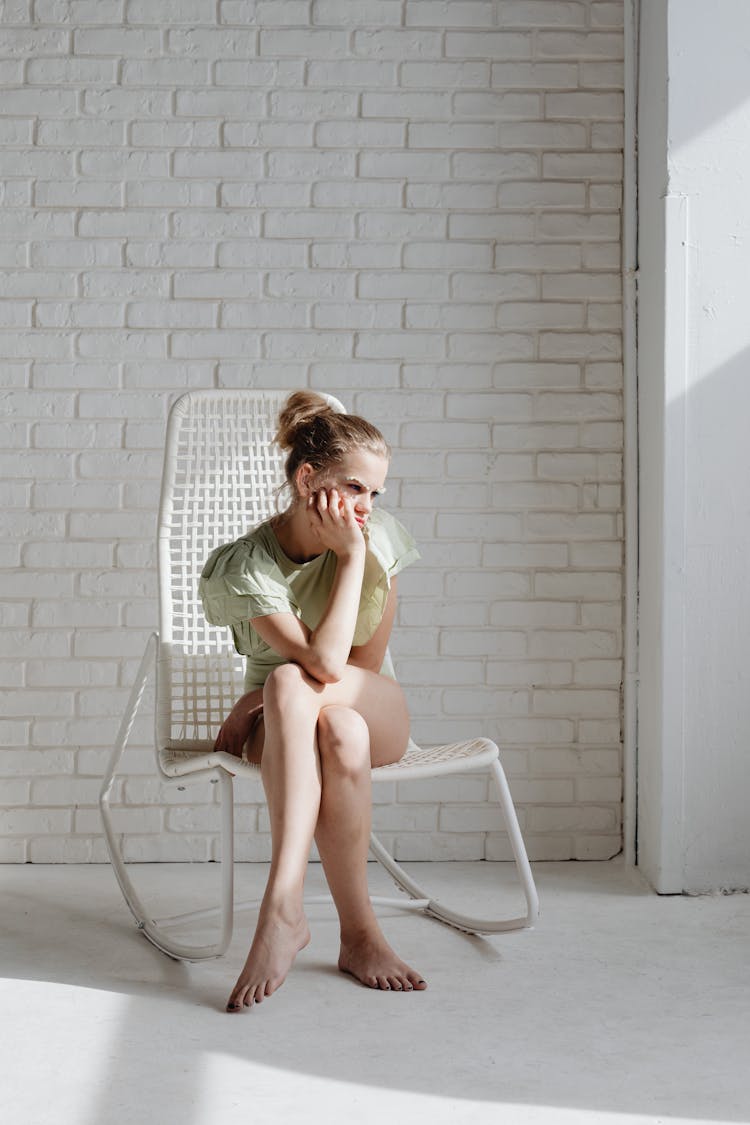 Woman In Green Dress Sitting On White Chair