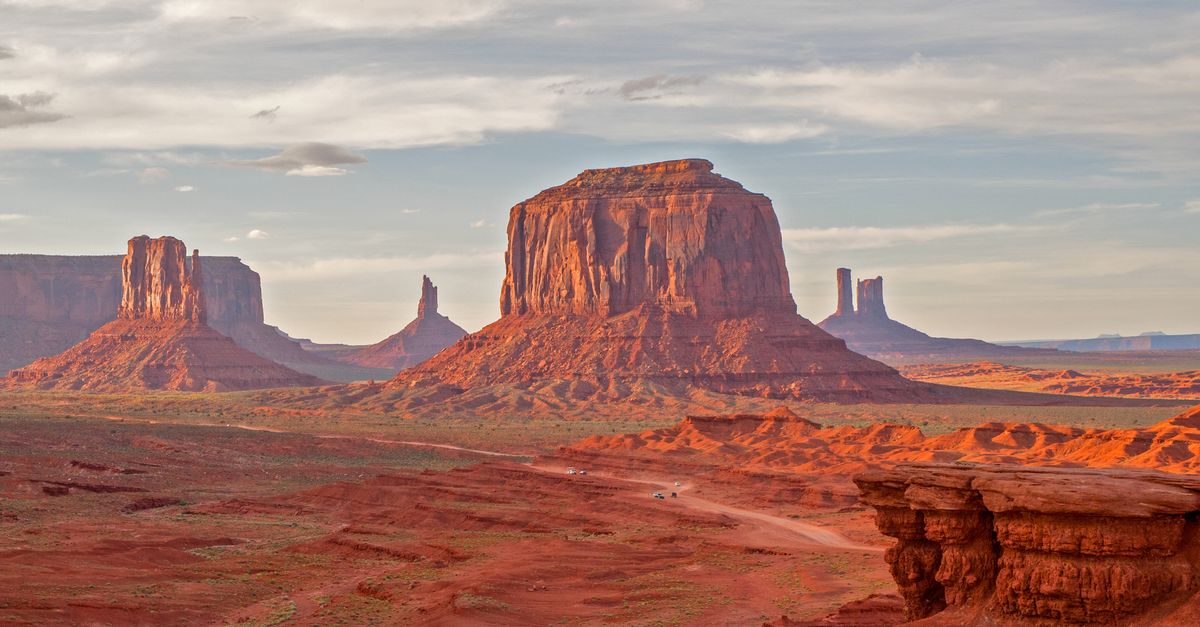 Breathtaking capture of Monument Valley's towering rock formations under a dramatic sky.
