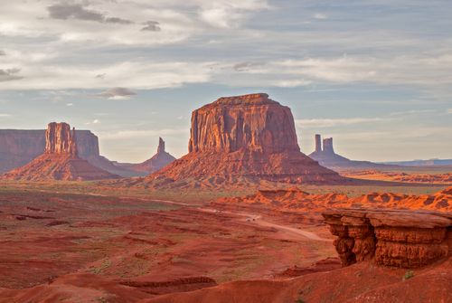 Free Breathtaking capture of Monument Valley's towering rock formations under a dramatic sky. Stock Photo
