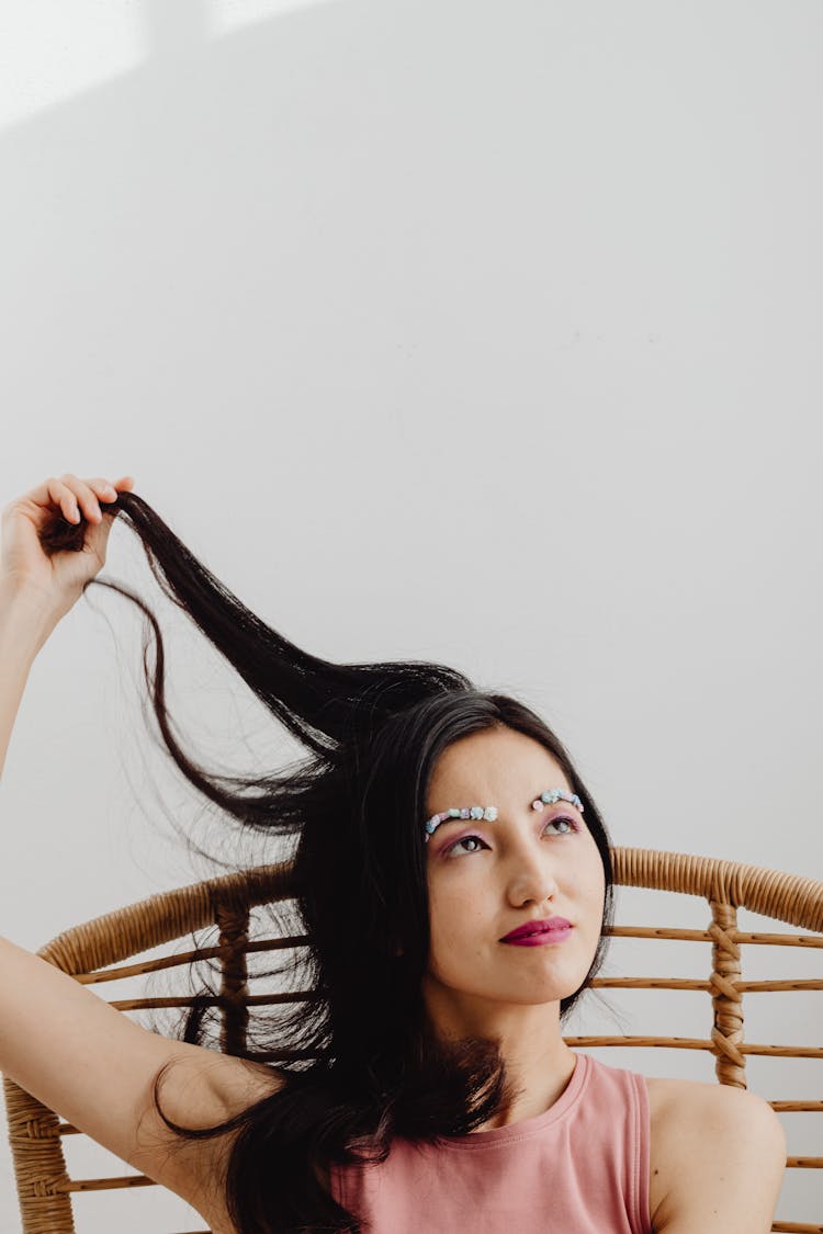 Woman Playing With Hair Looking Afar