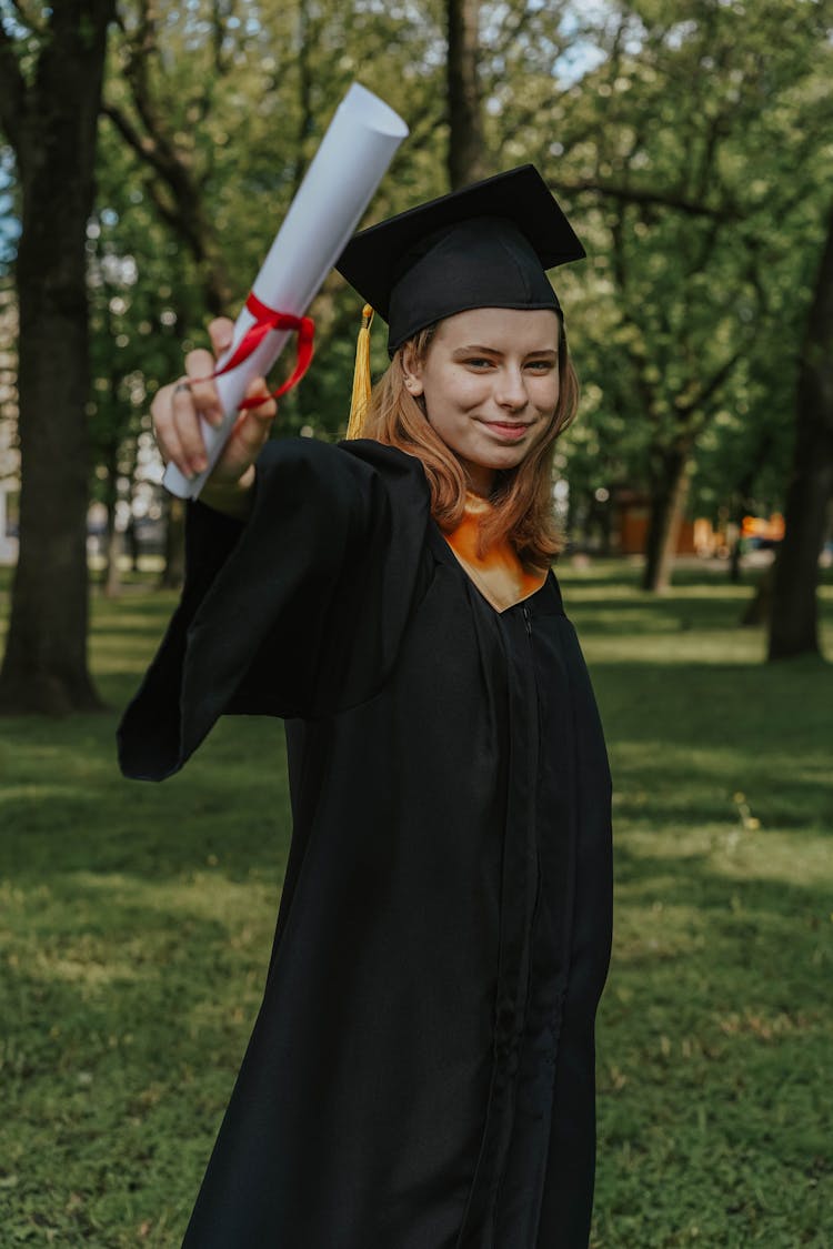 A Graduate Holding Her Diploma