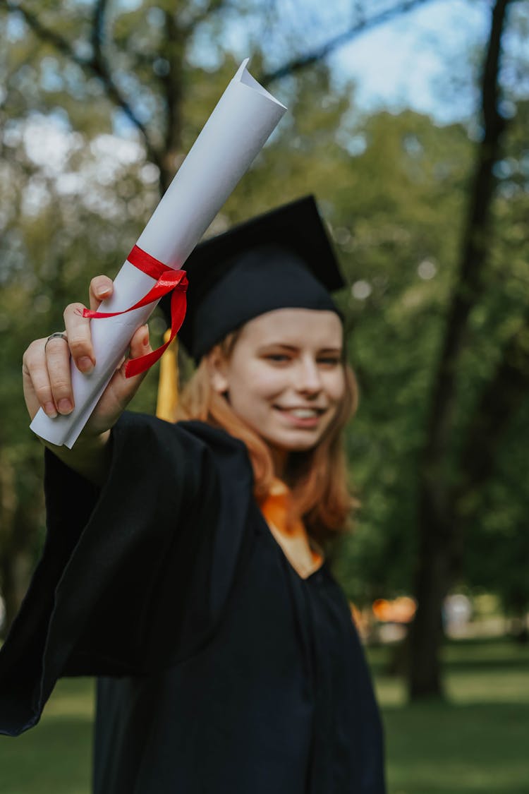 A Graduate Holding Her Diploma