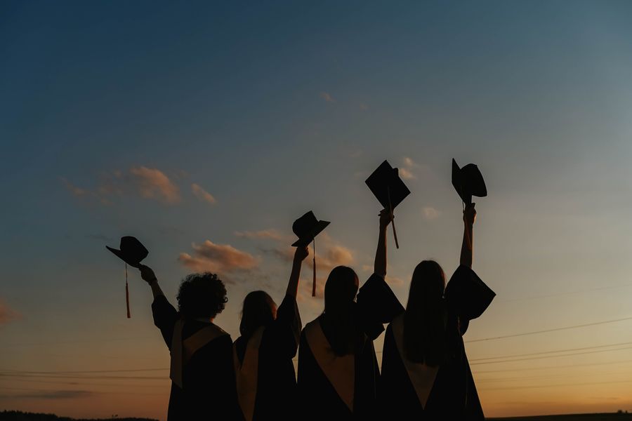 Graduates raising their caps