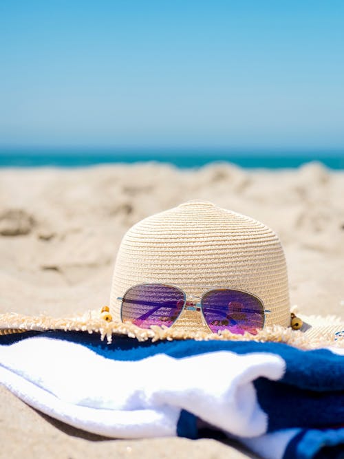 Free Hat and Sunglasses on a Towel Stock Photo