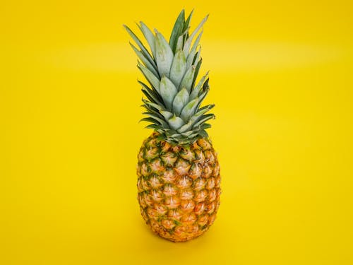Pineapple Fruit on Yellow Surface