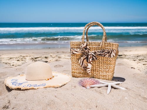 Free Brown Woven Bag on White Sand Beach Stock Photo