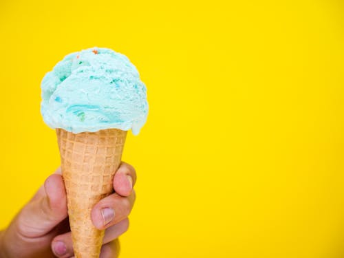 Free  A Hand Holding an Ice Cream Stock Photo
