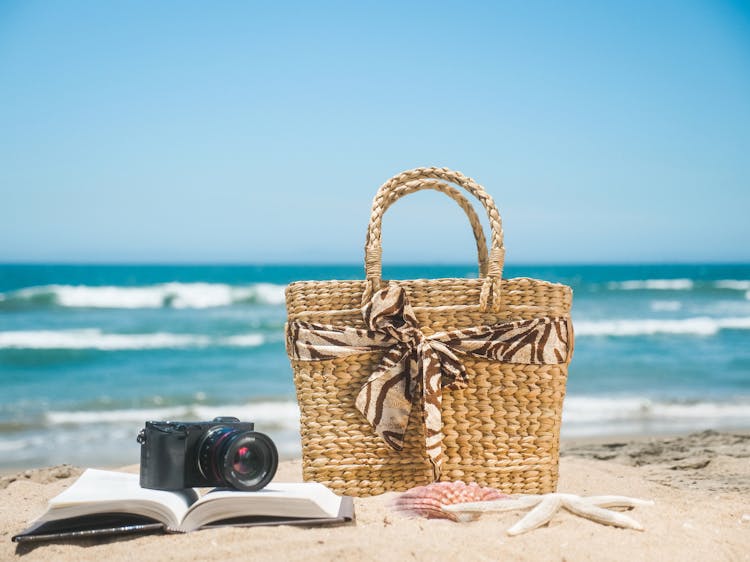 Brown Woven Bag On Beach Sand