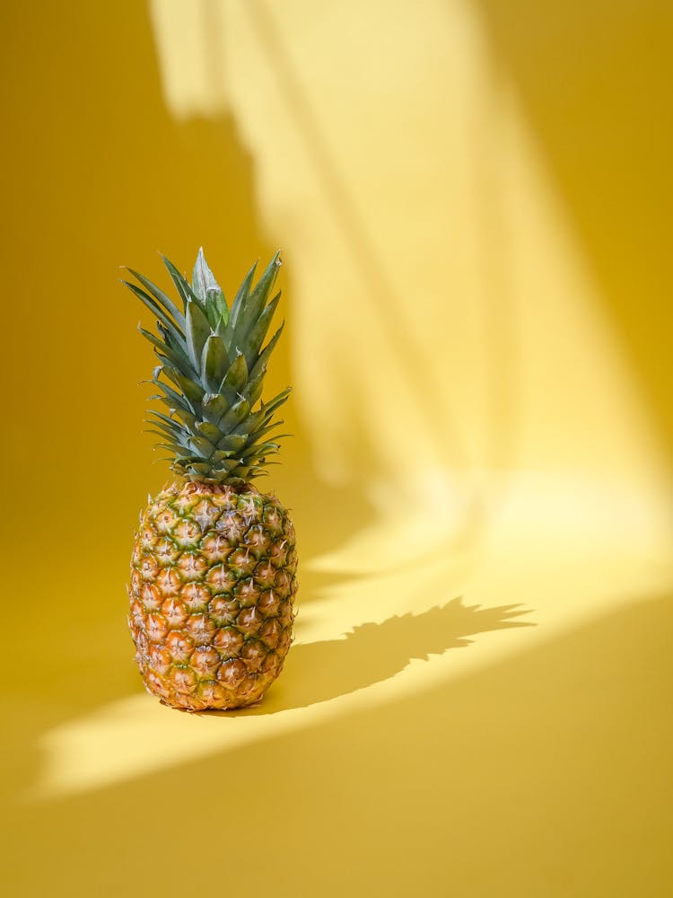 Pineapple Fruit On Yellow Surface