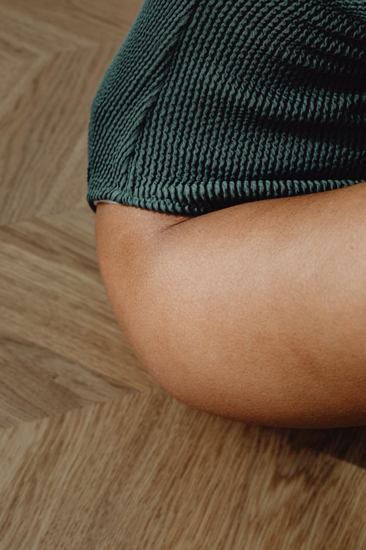 Skin Of The Hip Of A Woman Sitting On The Floor