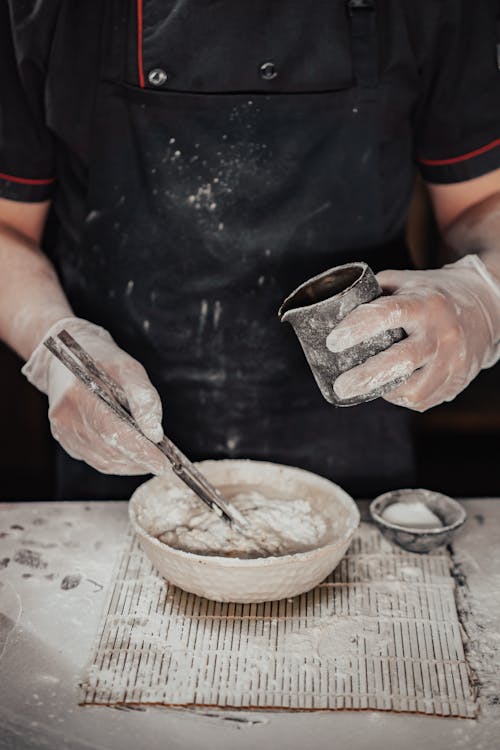 Person Making a Hand Mix Dough on Bowl