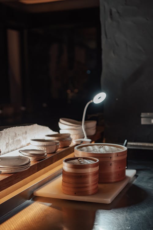 Kitchen Table with Baozi Steamer Baskets, and Bowls on a Shelf