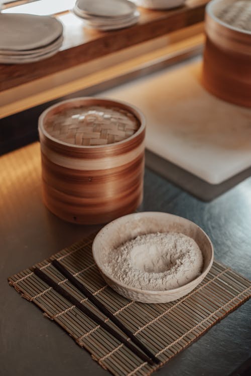 Bamboo Steamers, and a Bowl of Flour on a Mat