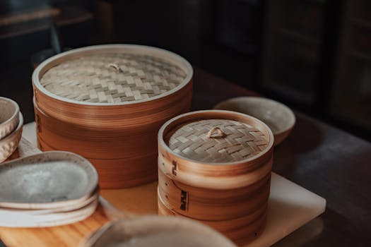Close-up of bamboo steamers in warm light, showcasing traditional Asian kitchenware.