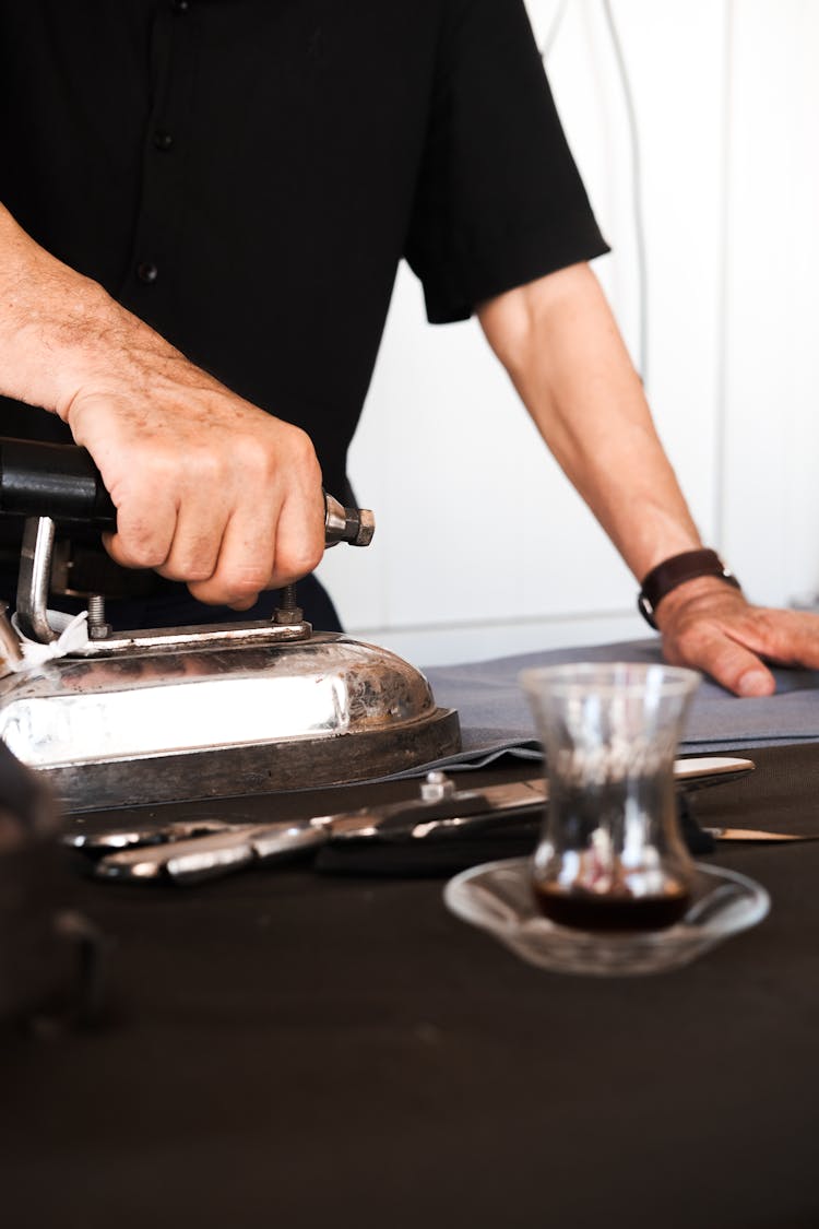 Man Using Old Fashioned Iron