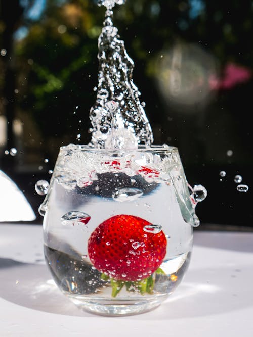 Free  Red Strawberry in Clear Glass of Water Stock Photo