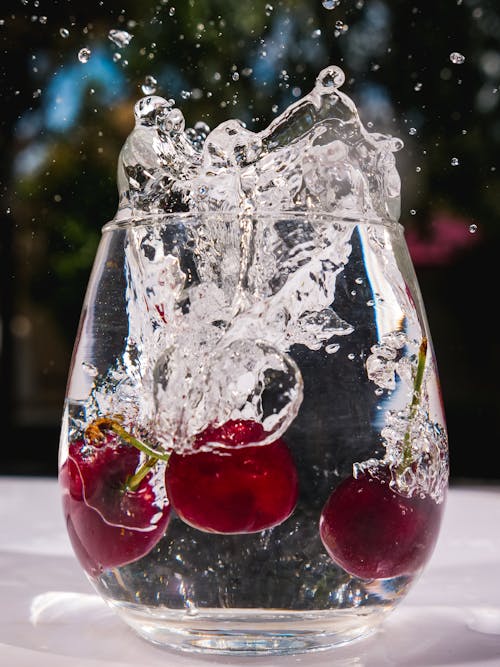 Photograph of Cherries Falling into a Glass