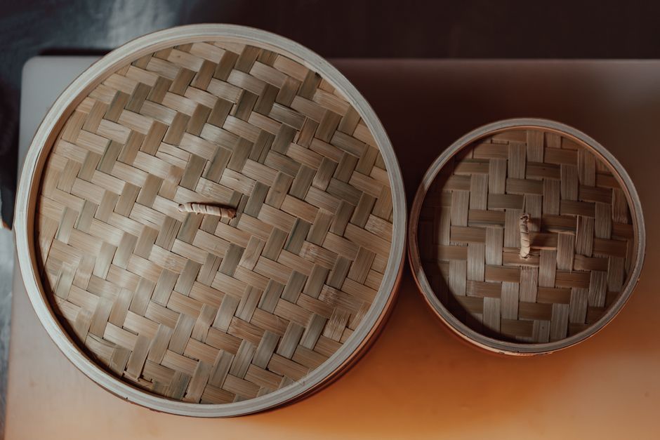 Stacked bamboo steamers showing woven construction and mesh layers`