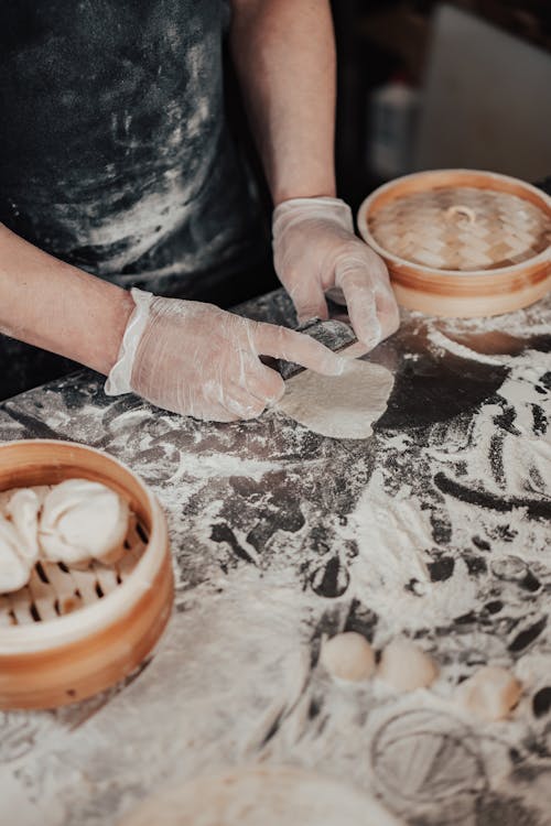 Free A Person Wearing Gloves while Making a Dumpling Stock Photo