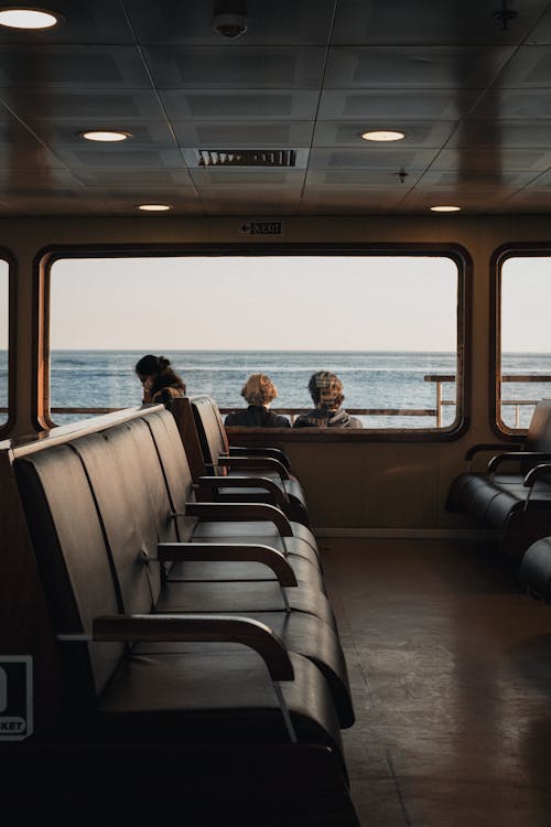 Free Calm view of sea from ship window with passengers seats and people on board Stock Photo