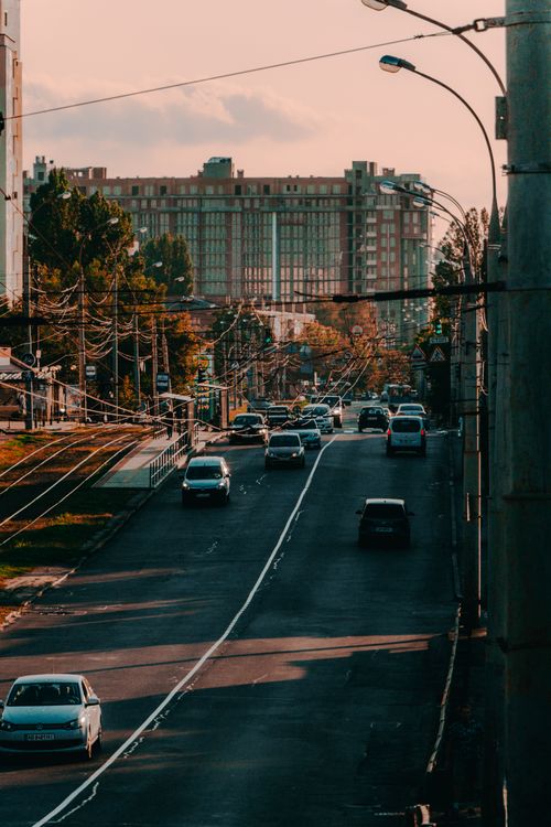 Free A city street bustling with traffic and tall buildings during dusk, creating a serene urban scene. Stock Photo