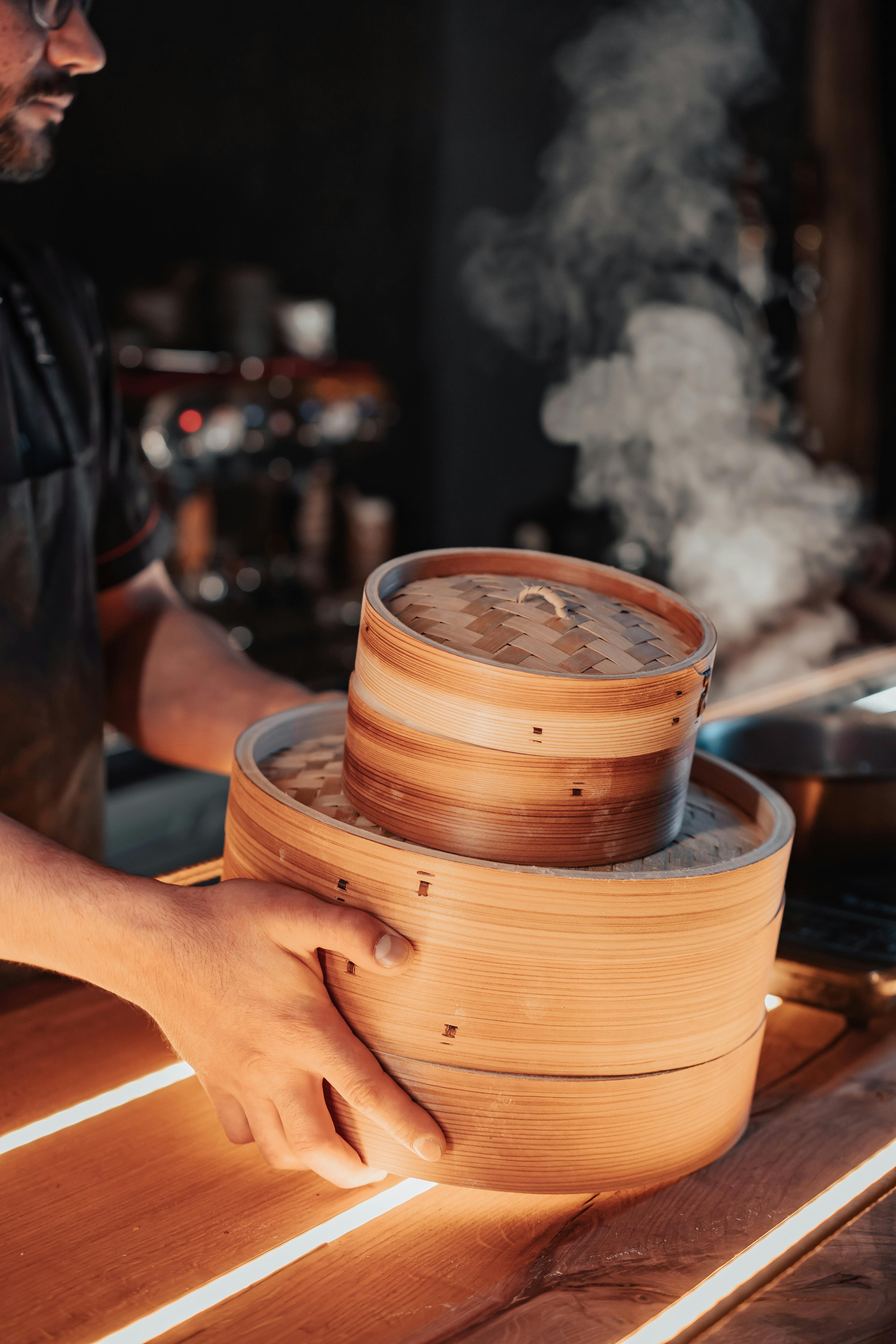 a person carrying bamboo steamer