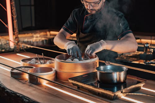 Chef in Black Uniform Cooking Dumplings