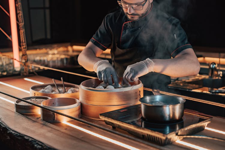 Chef In Black Uniform Cooking Dumplings