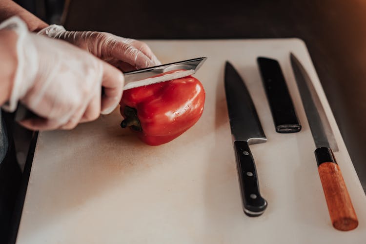 Person Slicing A Red Bell Pepper 