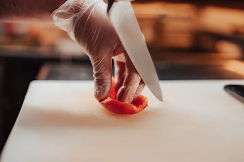 Free Person Slicing a Red Pepper Stock Photo