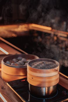 Bamboo steamers cooking delicious dumplings on a stovetop, releasing aromatic steam.