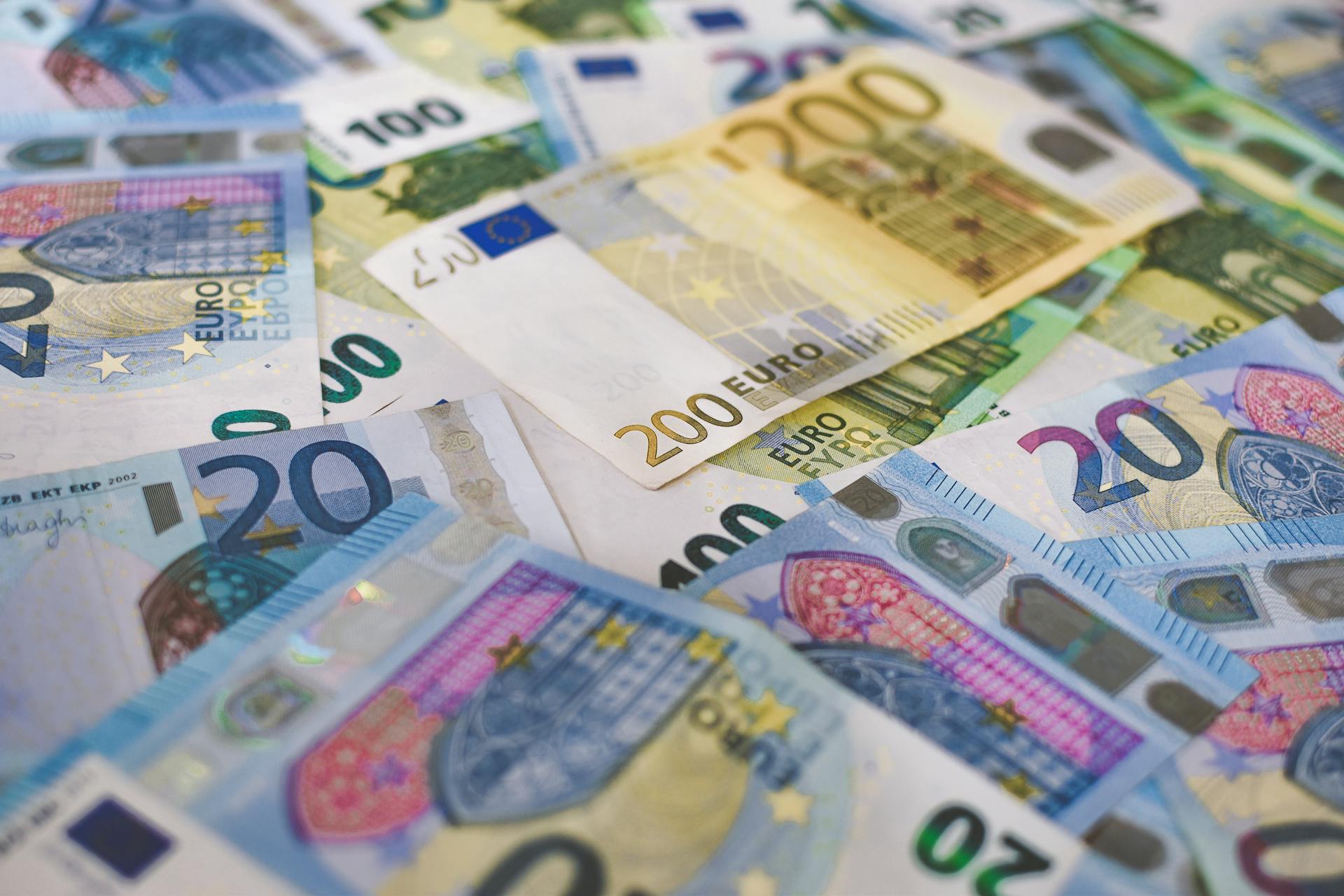 Close-up of Euro banknotes in different denominations, symbolizing wealth and finance.