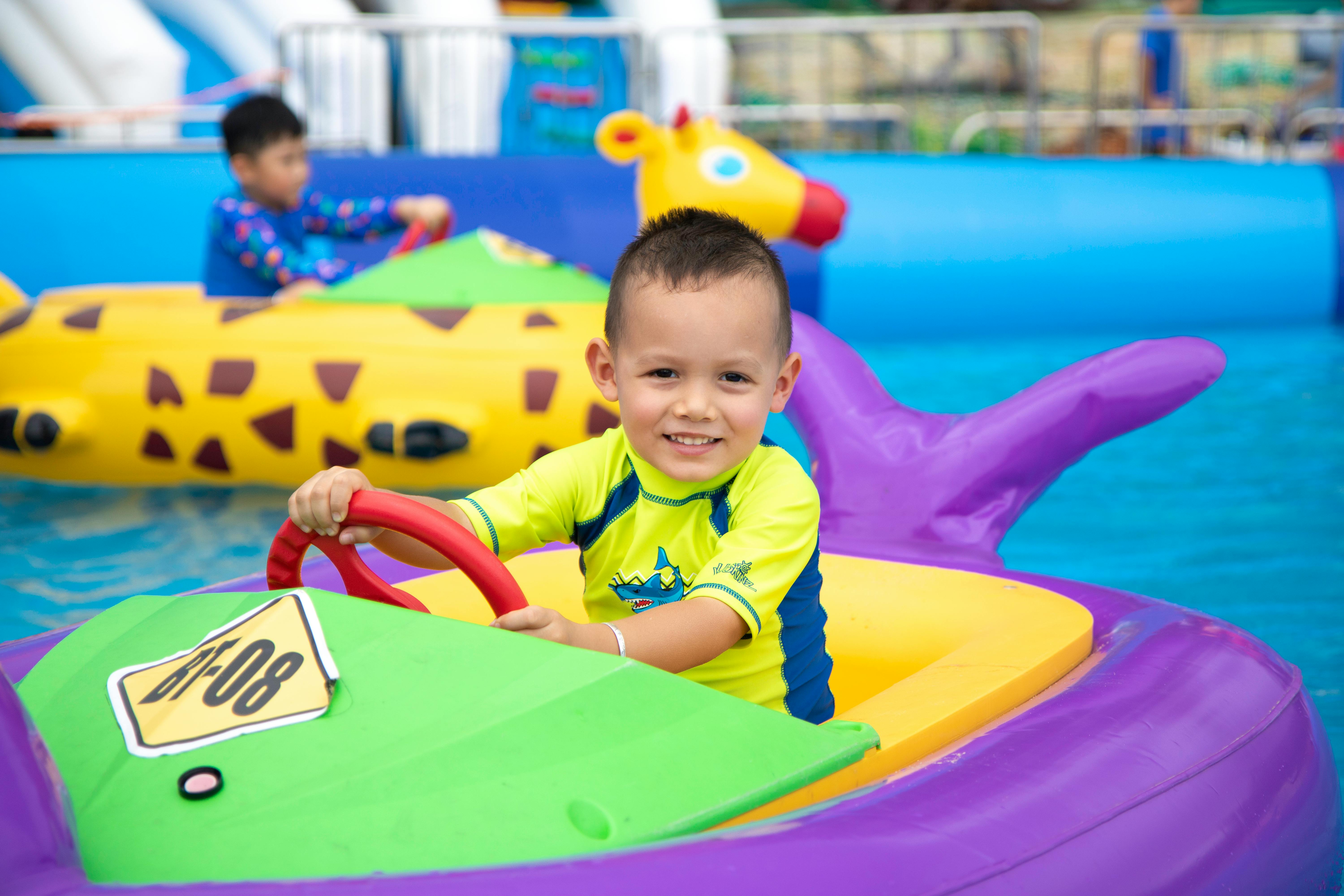 A Boy Riding a Floater on the Pool · Free Stock Photo