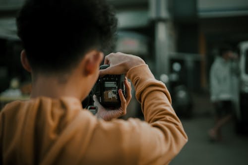Free Unrecognizable man photographing city on street Stock Photo