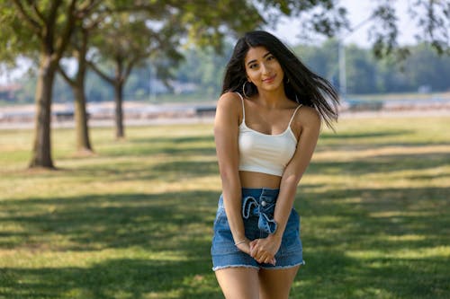 Woman Posing with Her Hands Together while Looking at the Camera