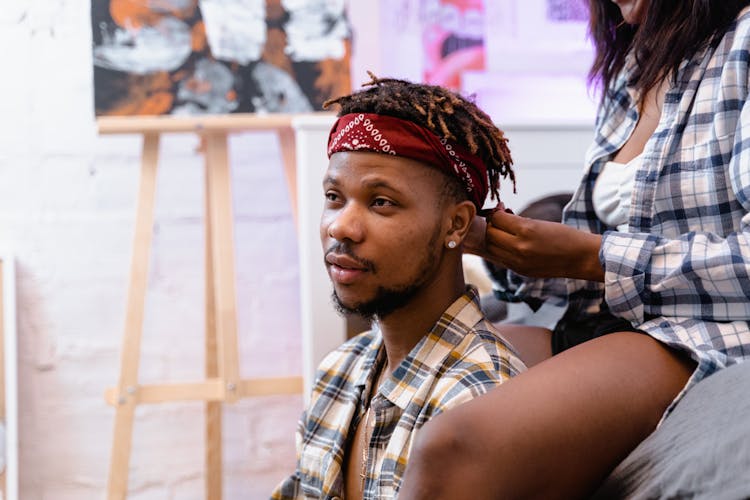 Woman Tying A Bandana On A Man's Head