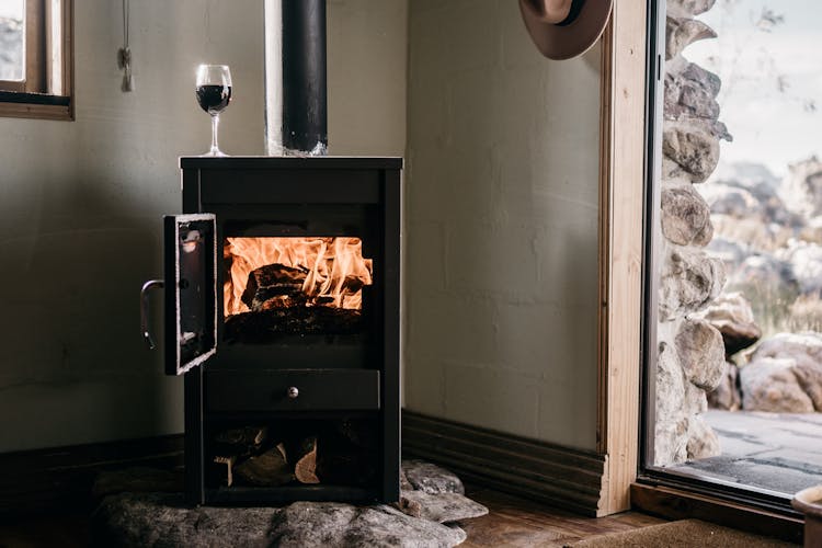 Wood Burning Stove On Corner Side Of A House