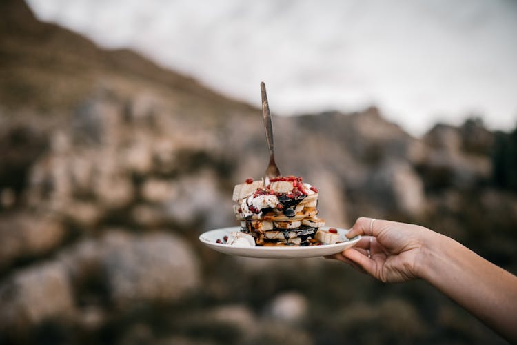 Hand Holding Plate With Pancakes