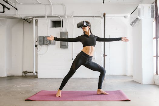 A woman in sportswear using a VR headset for yoga in a bright indoor space.