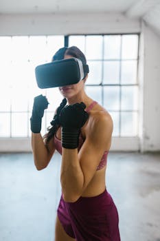 A woman wearing a VR headset and boxing gloves, practicing indoors.
