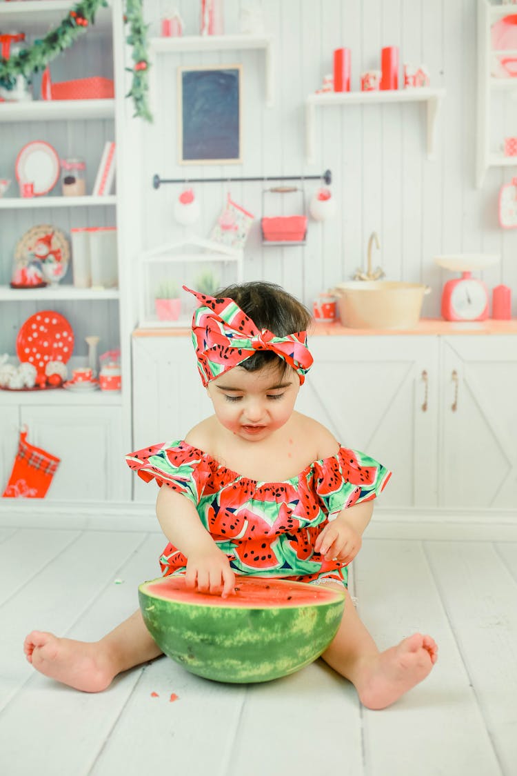 Cute Kid Playing With A Watermelon 